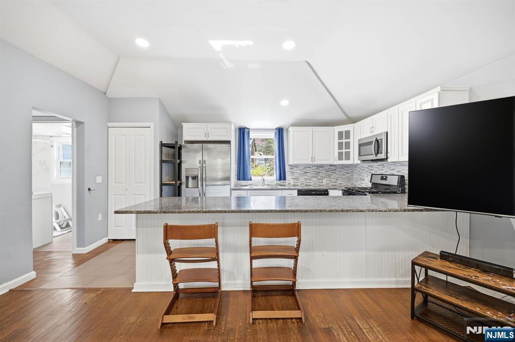 6 Timberwood Lane Oak Ridge, NJ 07438 - Photo 14 of 44 a kitchen with stainless steel appliances granite countertop a refrigerator and a stove top oven