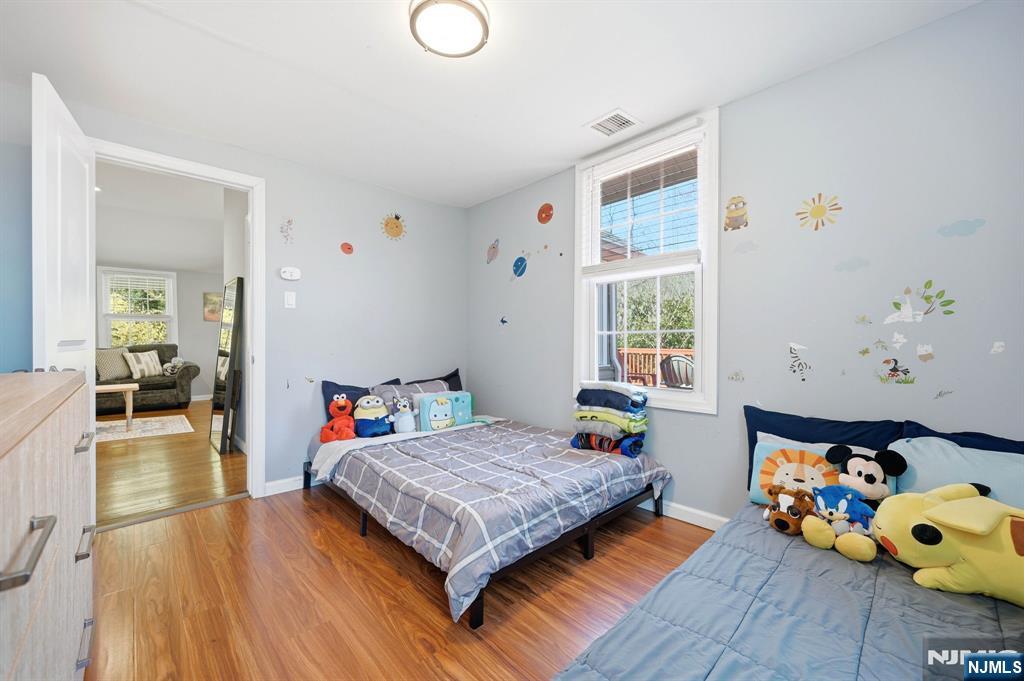 6 Timberwood Lane Oak Ridge, NJ 07438 - Photo 23 of 44 a bedroom with a bed and wooden floor
