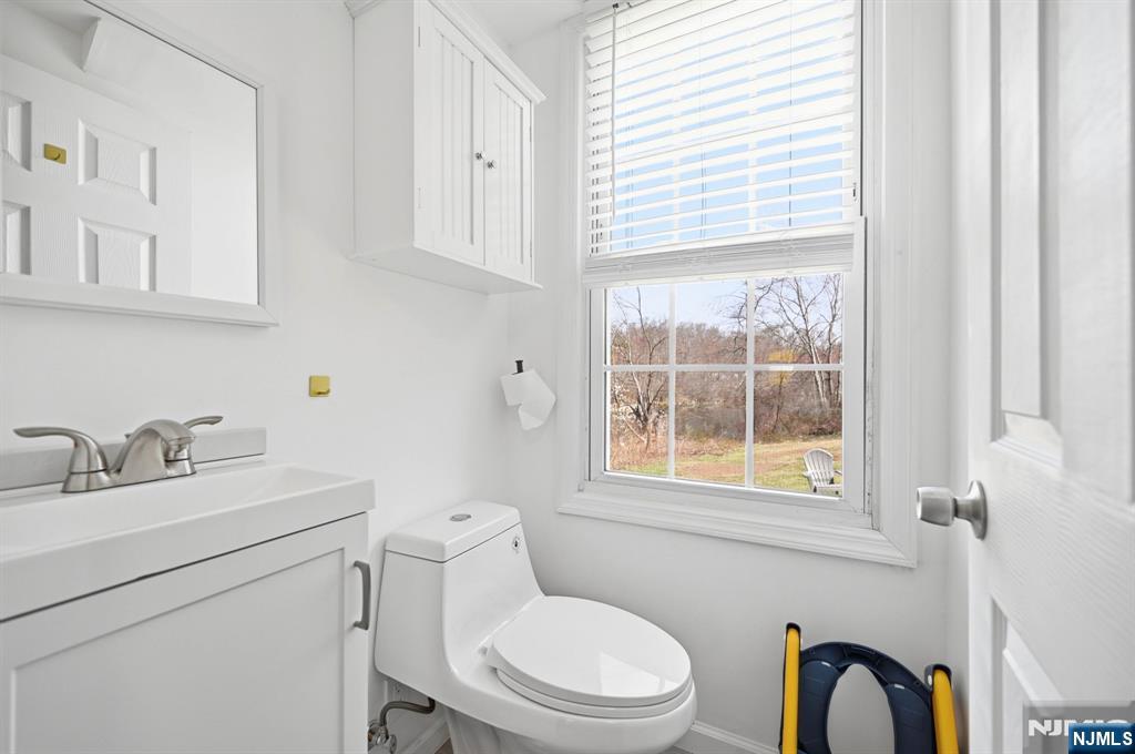 6 Timberwood Lane Oak Ridge, NJ 07438 - Photo 24 of 44 a bathroom with a sink a toilet and a window