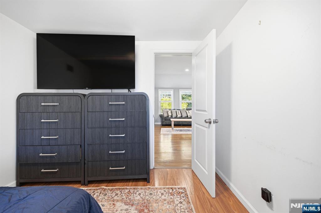 6 Timberwood Lane Oak Ridge, NJ 07438 - Photo 26 of 44 a living room with a dresser and a flat screen tv