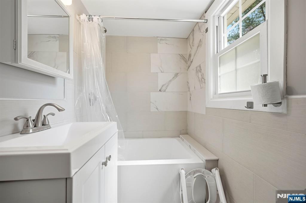 6 Timberwood Lane Oak Ridge, NJ 07438 - Photo 31 of 44 a bathroom with a sink a vanity and a shower