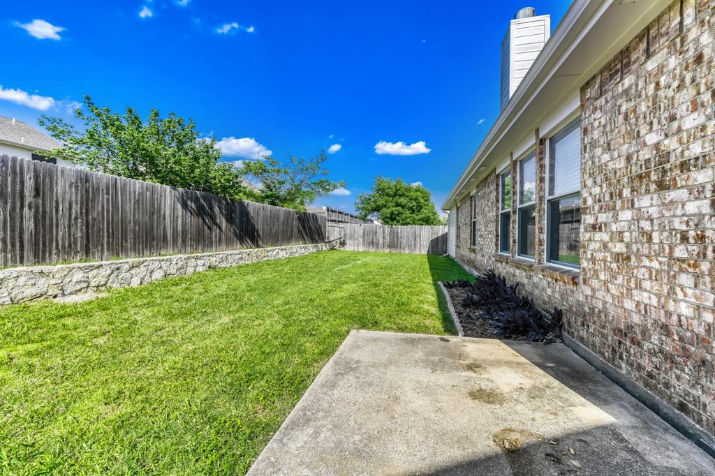 2617 Hereford Road Denton, TX 76210 - Photo 25 of 27 a view of a backyard with a garden