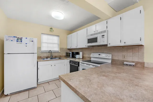 a kitchen with cabinets appliances and a counter space