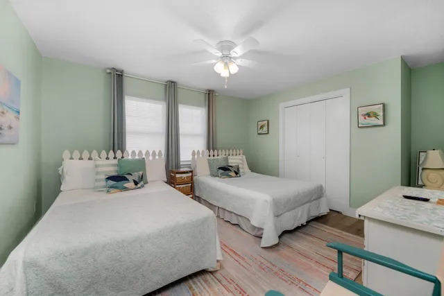 a bedroom with two beds and a chandelier