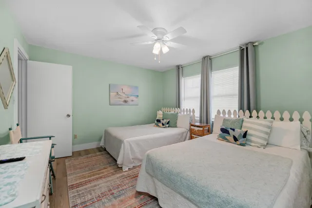 a bedroom with two beds and a chandelier