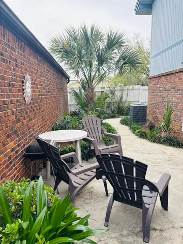 a view of backyard with outdoor seating a patio and plants