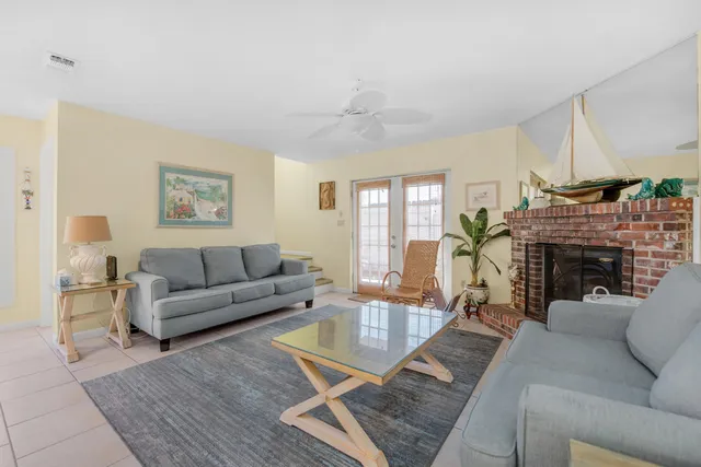 a living room with furniture a fireplace and a table