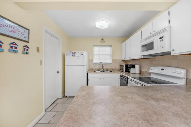 a kitchen with stainless steel appliances a refrigerator sink and cabinets