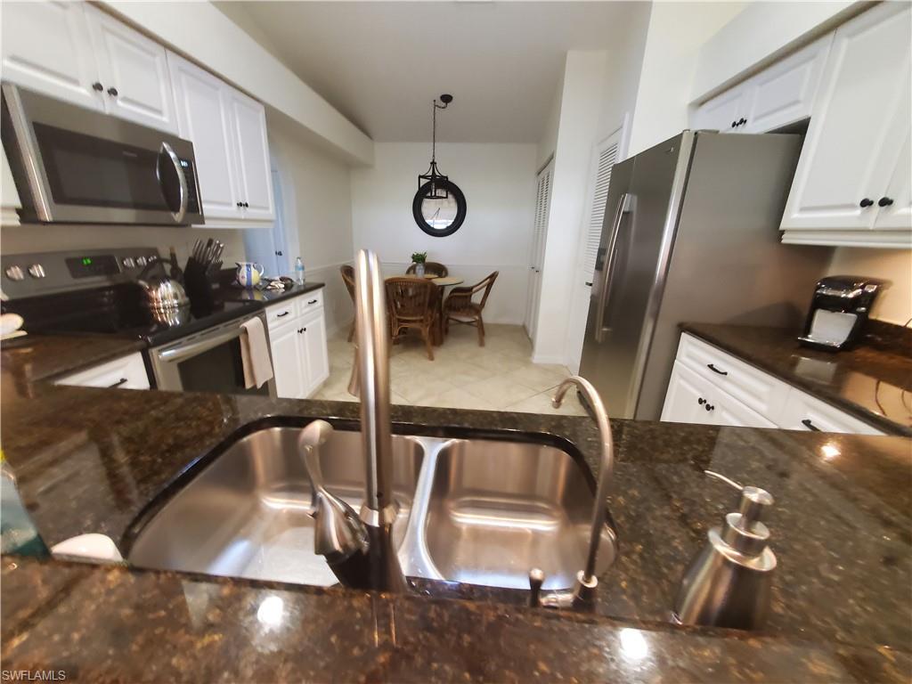 992 Marblehead Drive Naples, FL 34104 - Photo 12 of 50 a kitchen with a sink appliances and cabinets