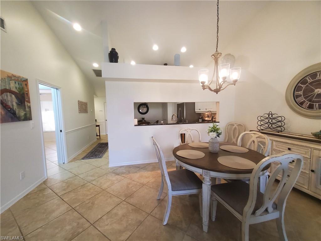 992 Marblehead Drive Naples, FL 34104 - Photo 14 of 50 a view of a dining room with furniture and chandelier