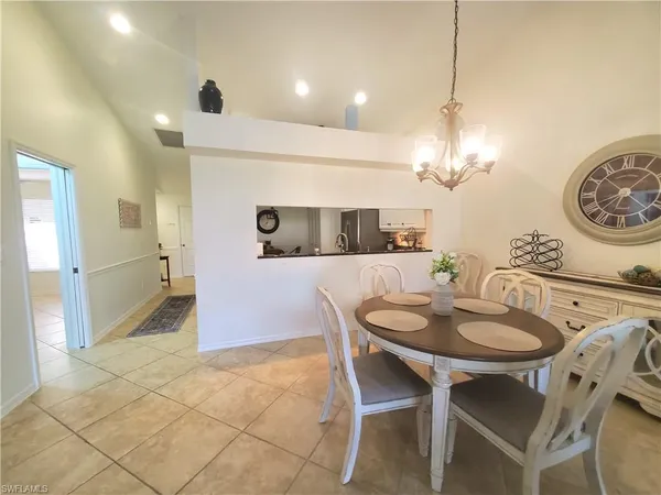 a dining room with furniture and chandelier