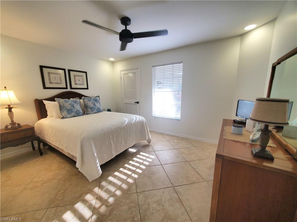 992 Marblehead Drive Naples, FL 34104 - Photo 19 of 50 a bedroom with a large bed and a window