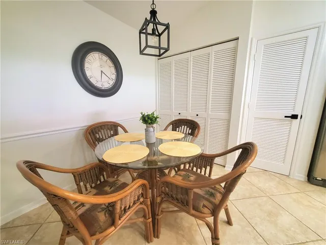 a view of a dining room with furniture and a window