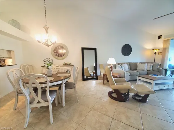 a living room with furniture a clock and a large mirror