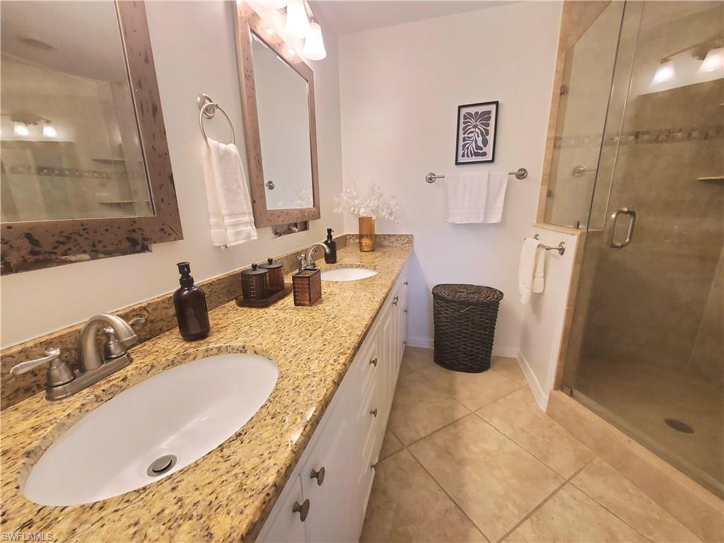 992 Marblehead Drive Naples, FL 34104 - Photo 32 of 50 a bathroom with a granite countertop sink and a mirror
