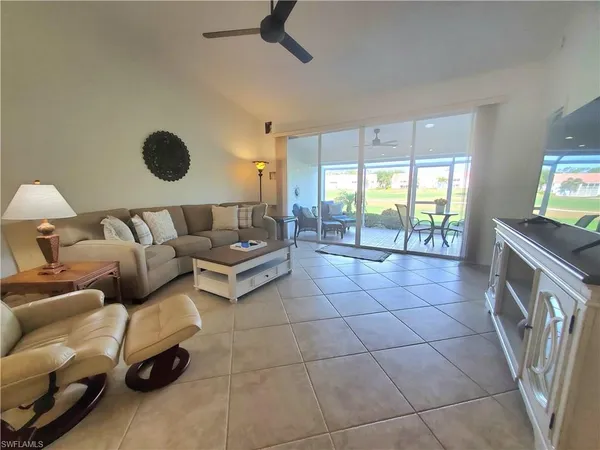 a living room with a couch and a stove next to a window
