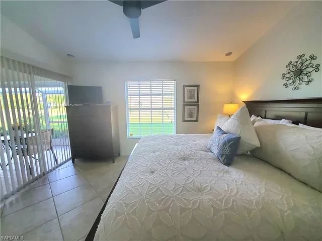 a spacious bedroom with a bed and a window