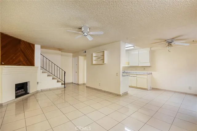 a view of a livingroom with an empty space and a fireplace