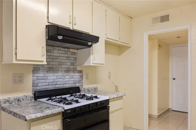 a kitchen with a stove and a refrigerator