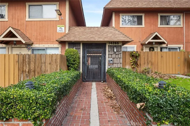 a view of a brick house with large windows