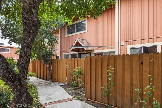 a view of a house with a tree beside it