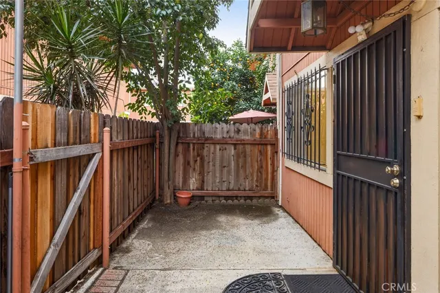 a view of a pathway of a house with wooden fence