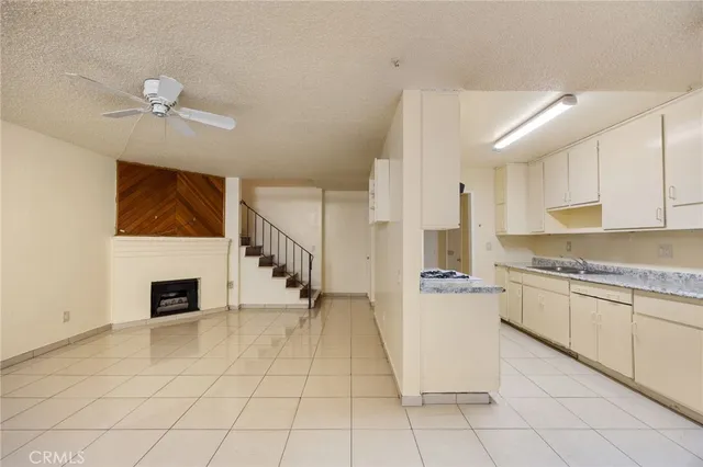 a kitchen with a cabinets a sink and a stove top oven