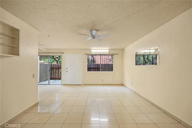 a view of a livingroom with an empty space and a ceiling fan