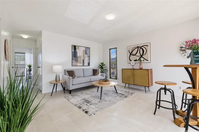 a living room with furniture and a potted plant