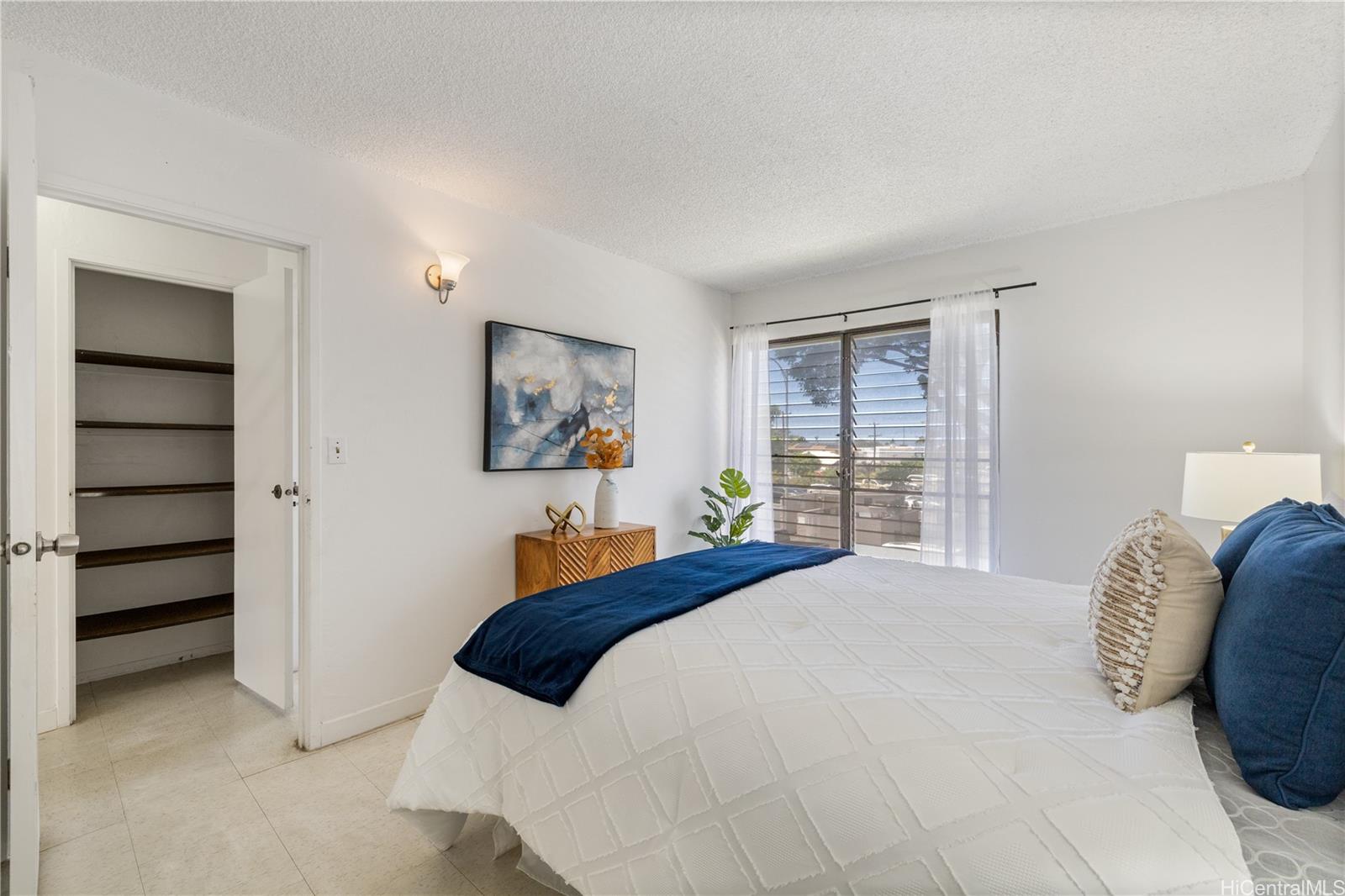 87-119 Helelua Street, Unit F204 Waianae, HI 96792 - Photo 14 of 24 a bedroom with a bed and a window