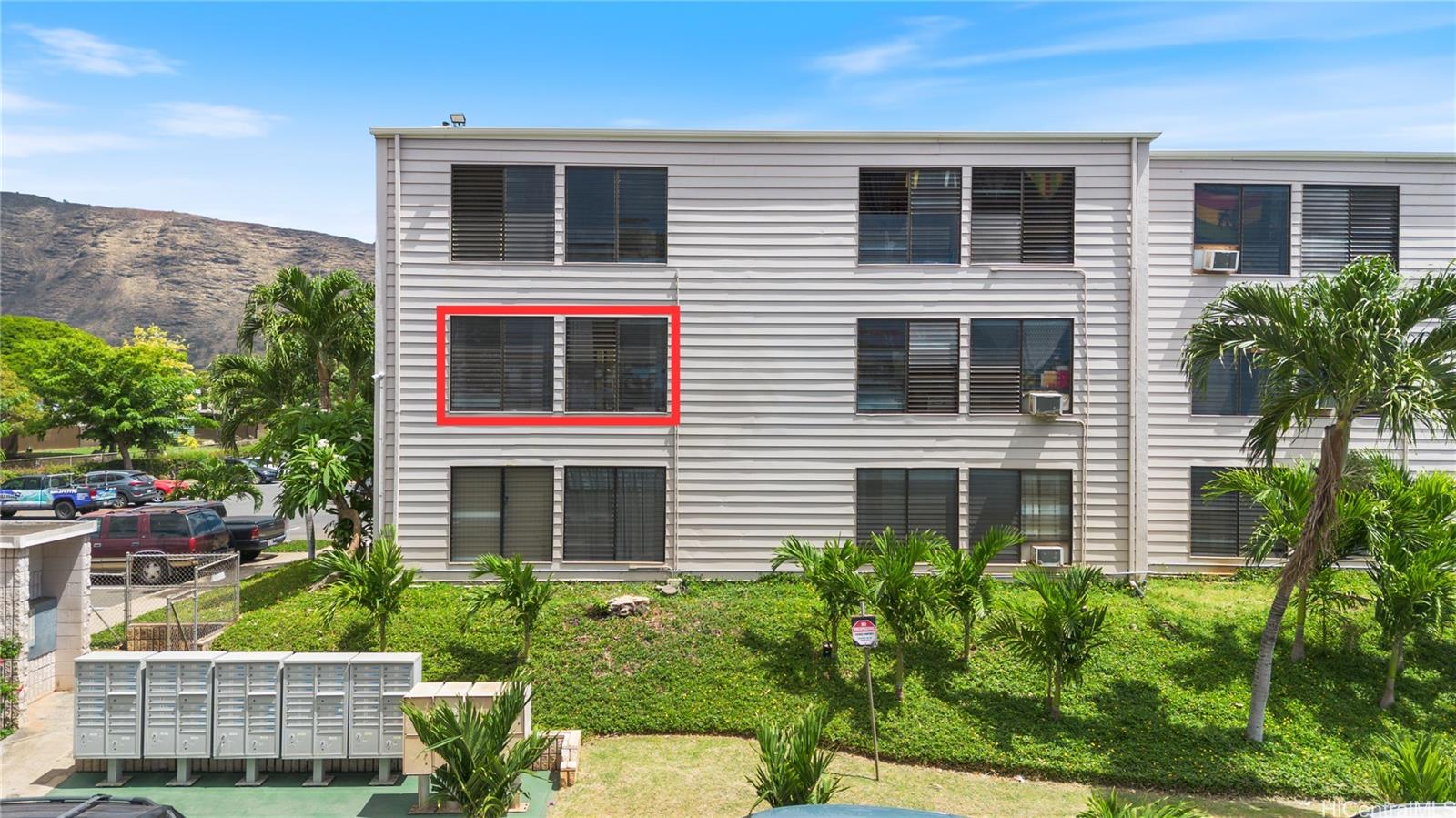 87-119 Helelua Street, Unit F204 Waianae, HI 96792 - Photo 20 of 24 a front view of a house with a yard and garage