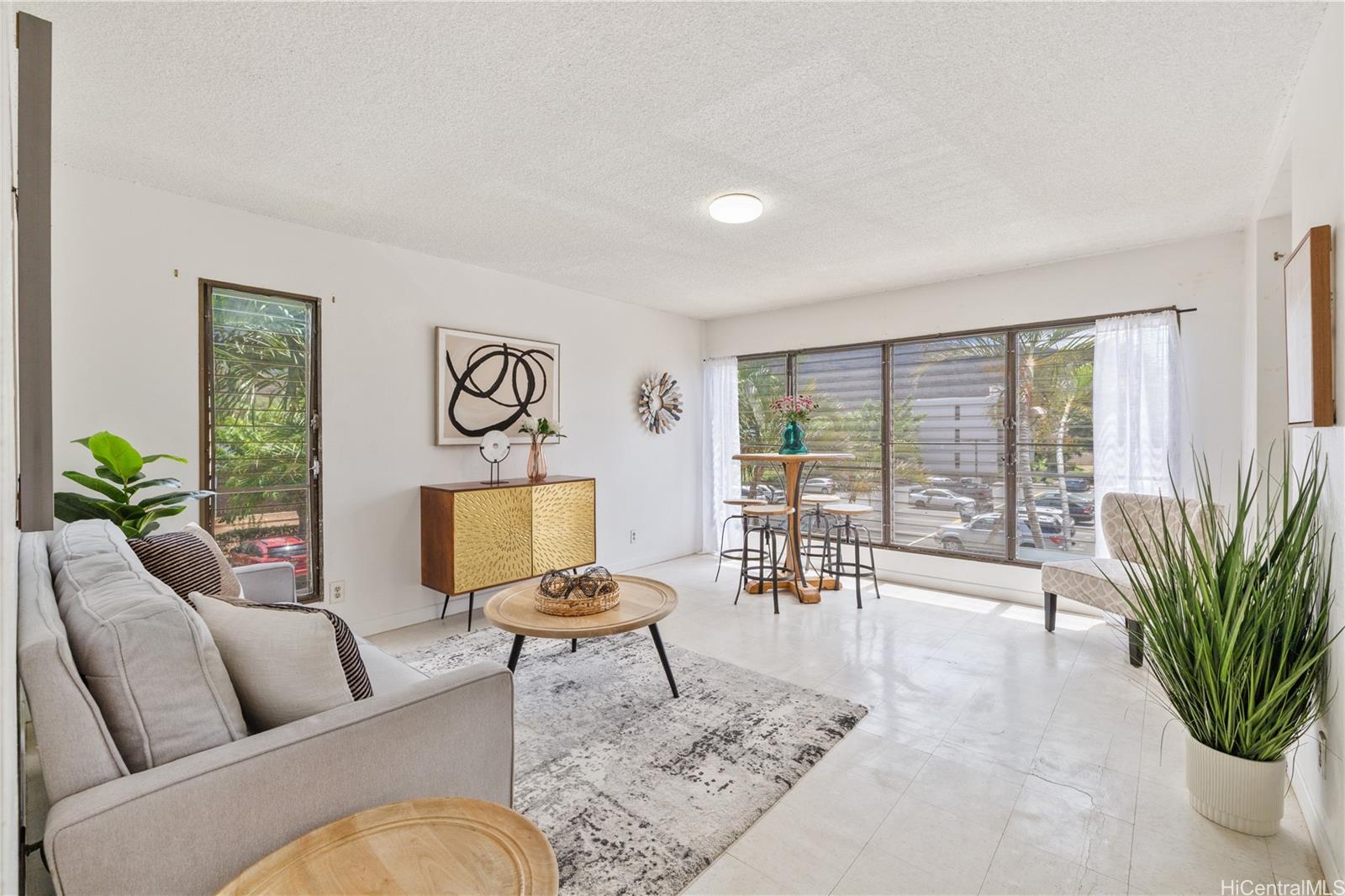 87-119 Helelua Street, Unit F204 Waianae, HI 96792 - Photo 3 of 24 a living room with furniture and a potted plant
