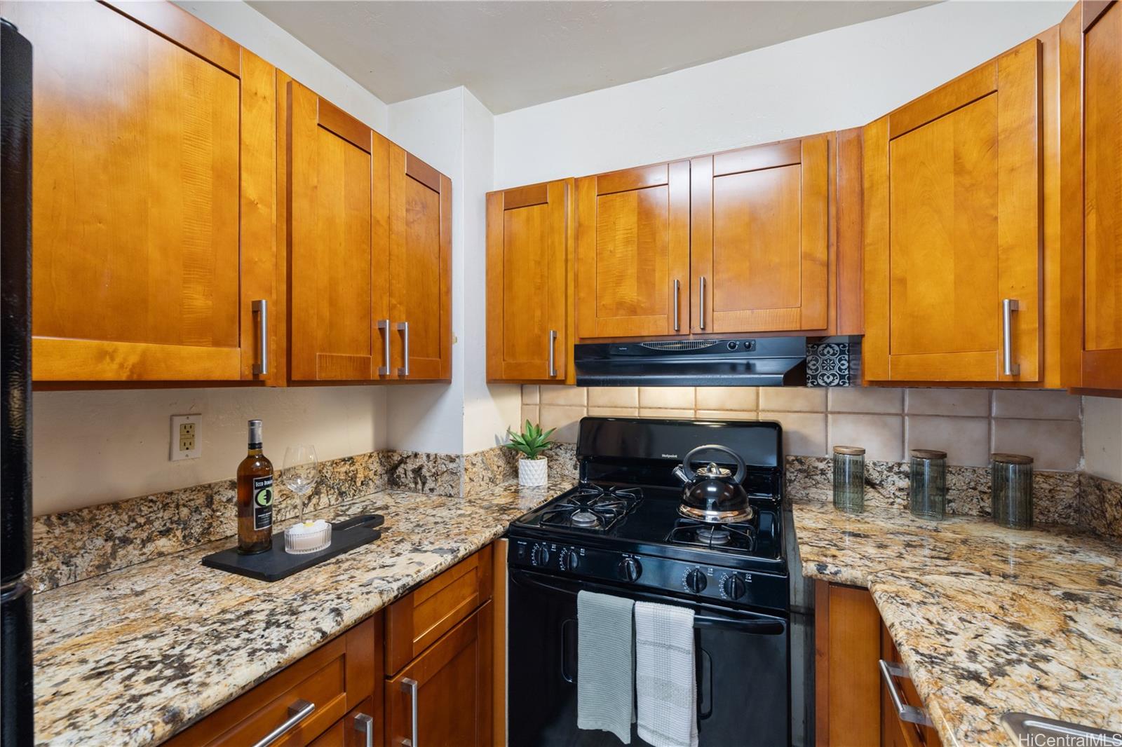 87-119 Helelua Street, Unit F204 Waianae, HI 96792 - Photo 7 of 24 a kitchen with a stove top oven sink and cabinets
