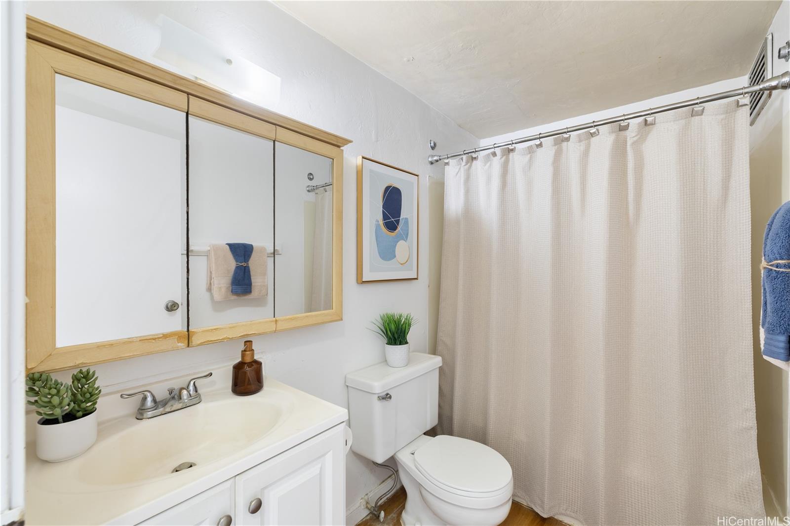 87-119 Helelua Street, Unit F204 Waianae, HI 96792 - Photo 9 of 24 a bathroom with a sink and a mirror
