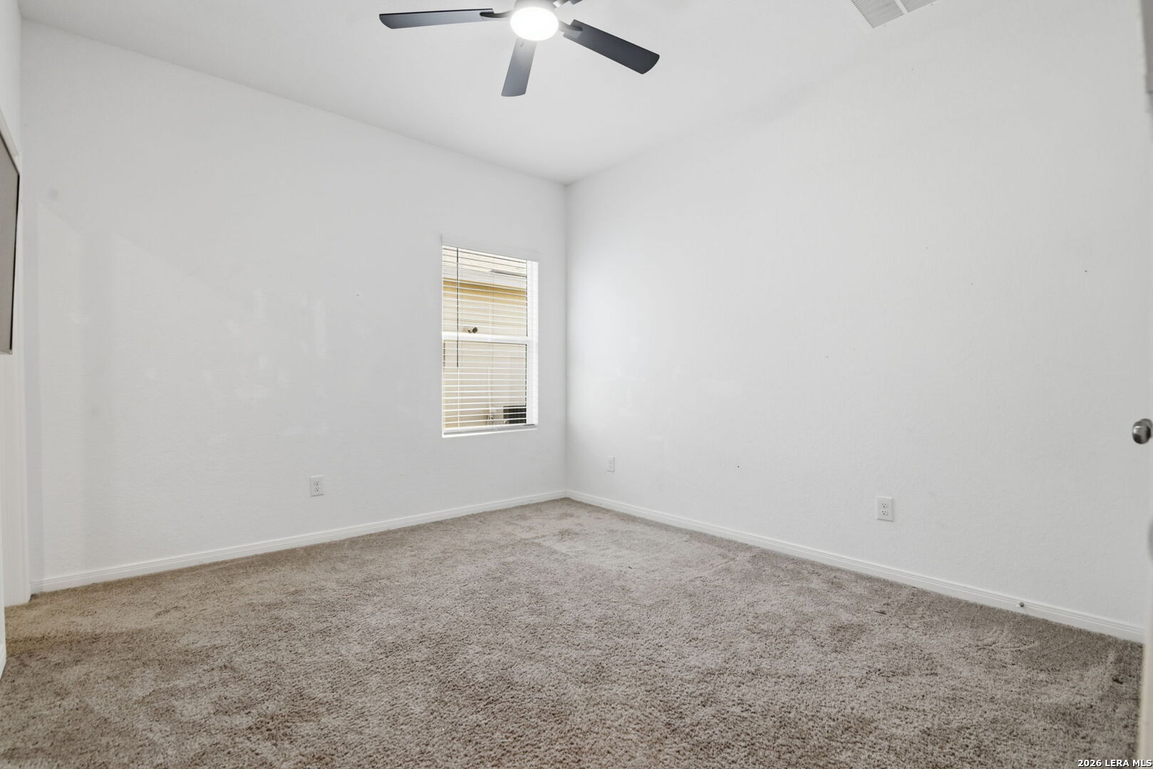 12811 Sage Turn St. Hedwig, TX 78152 - Photo 17 of 28 an empty room with a chandelier fan and windows