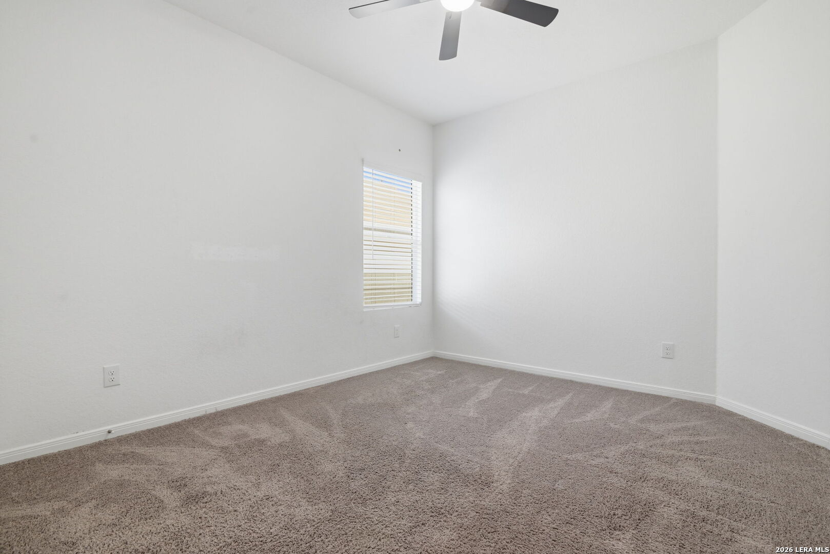 12811 Sage Turn St. Hedwig, TX 78152 - Photo 23 of 28 an empty room with a window and ceiling fan