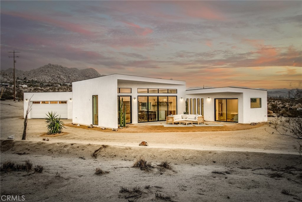 64342 Hollinger Road Joshua Tree, CA 92252 - Photo 1 of 1 a view of a house with wooden floor and a big yard