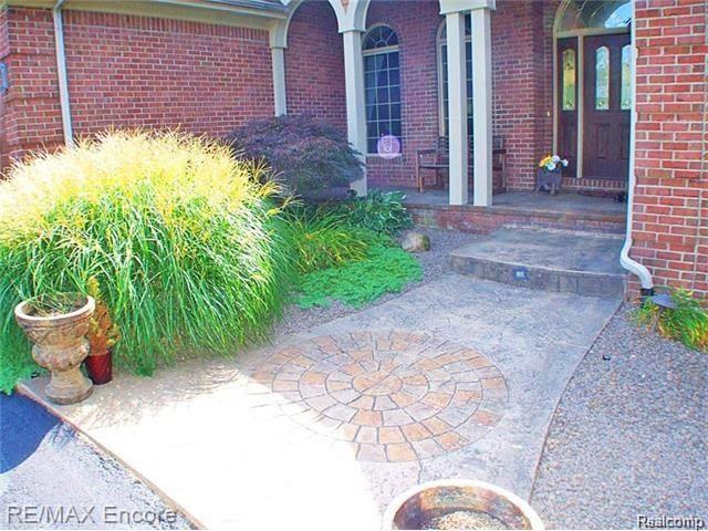 8629 Sashabaw Road Clarkston, MI 48348 - Photo 6 of 34 Stamped concrete sidewalk welcomes guests