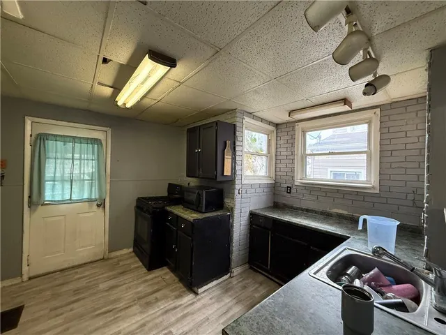 a kitchen with stainless steel appliances granite countertop a sink stove and wooden cabinets