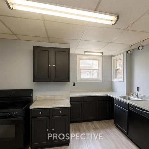 a kitchen with a sink stove and microwave