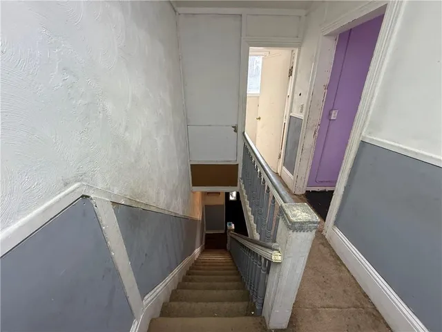 a view of a room with wooden floor