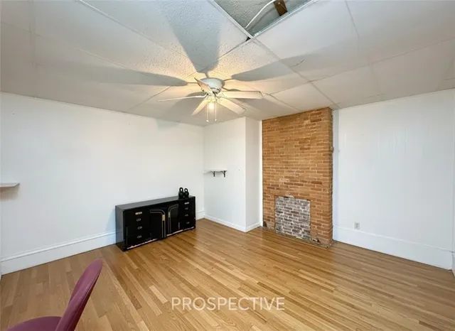 wooden floor in a room next to a window