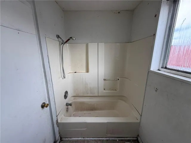 a view of a house with a wooden deck and furniture