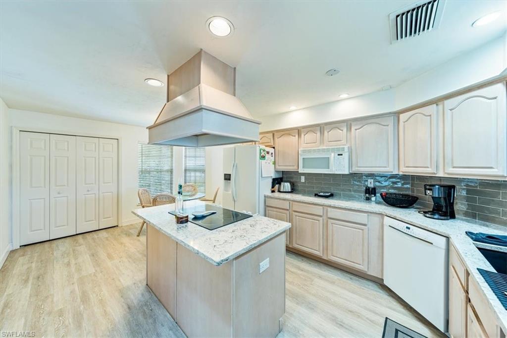 231 Via Perignon, Unit 204 Naples, FL 34119 - Photo 12 of 26 a kitchen with a sink stove and cabinets