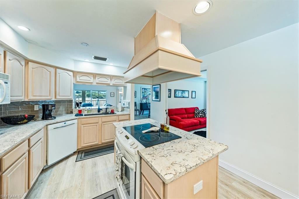 231 Via Perignon, Unit 204 Naples, FL 34119 - Photo 14 of 26 a kitchen with stainless steel appliances granite countertop a stove and cabinets