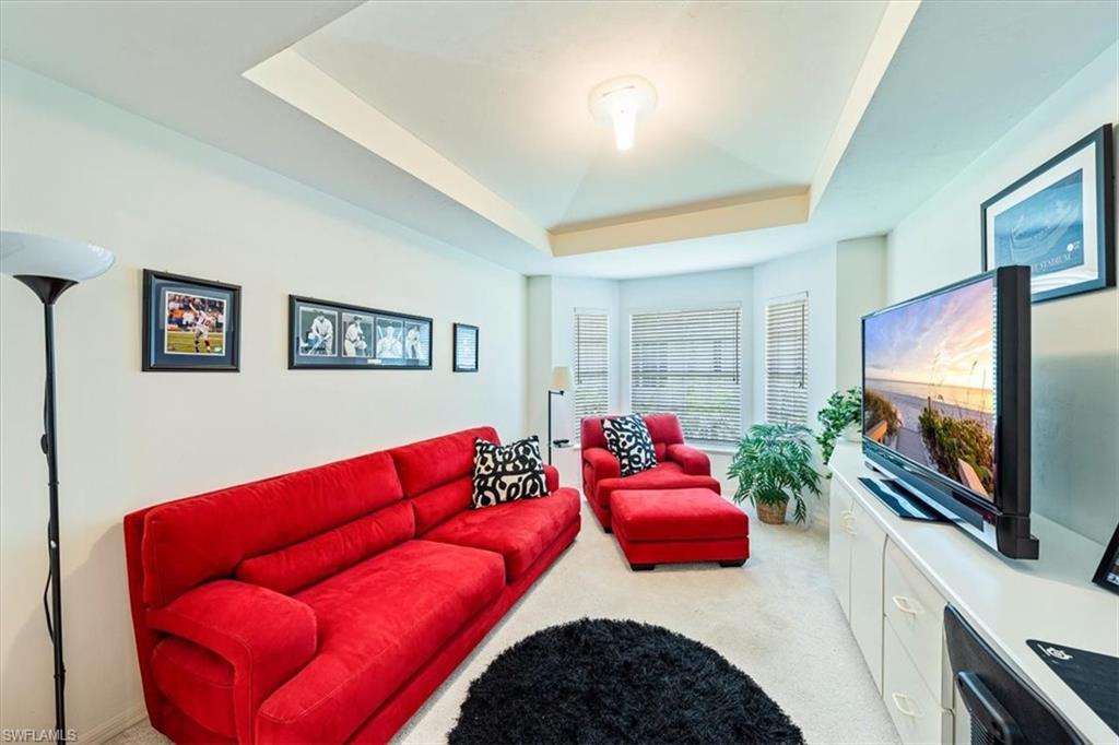 231 Via Perignon, Unit 204 Naples, FL 34119 - Photo 15 of 26 a living room with furniture kitchen view and a flat screen tv
