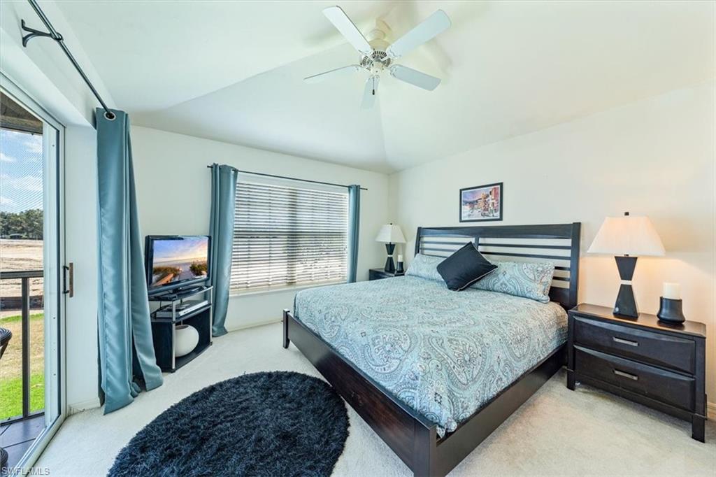 231 Via Perignon, Unit 204 Naples, FL 34119 - Photo 23 of 26 a bedroom with a bed and a dresser next to a window