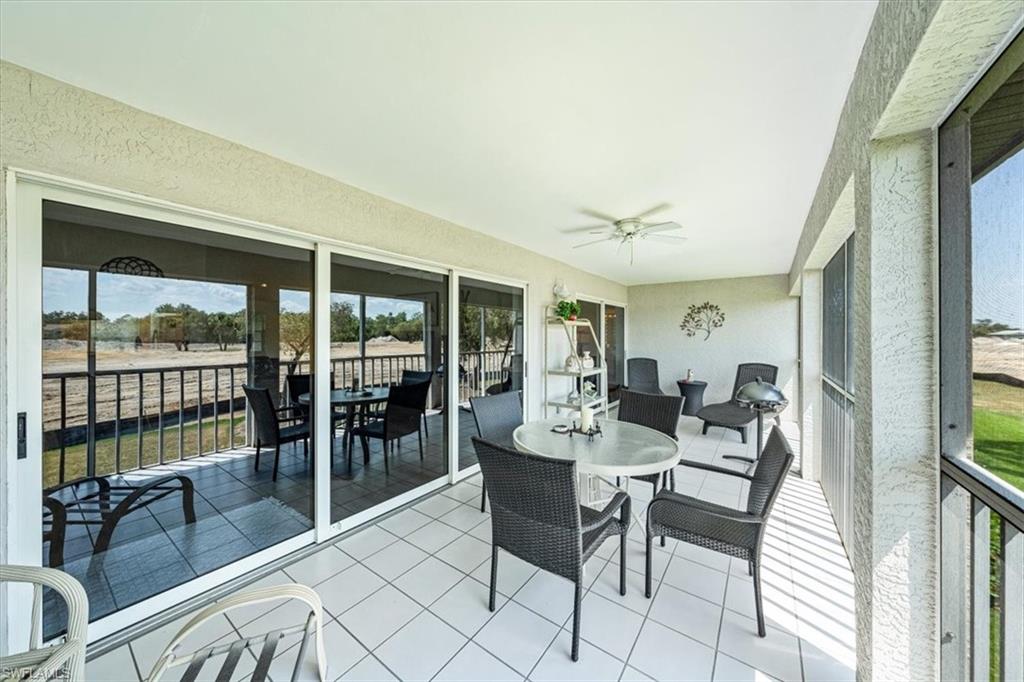 231 Via Perignon, Unit 204 Naples, FL 34119 - Photo 25 of 26 a dining room with furniture and large windows