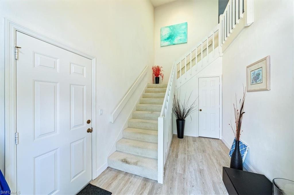 231 Via Perignon, Unit 204 Naples, FL 34119 - Photo 3 of 26 a view of entryway with wooden floor and stairs