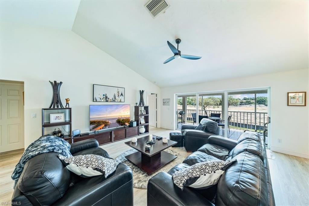 231 Via Perignon, Unit 204 Naples, FL 34119 - Photo 6 of 26 a living room with furniture and a flat screen tv